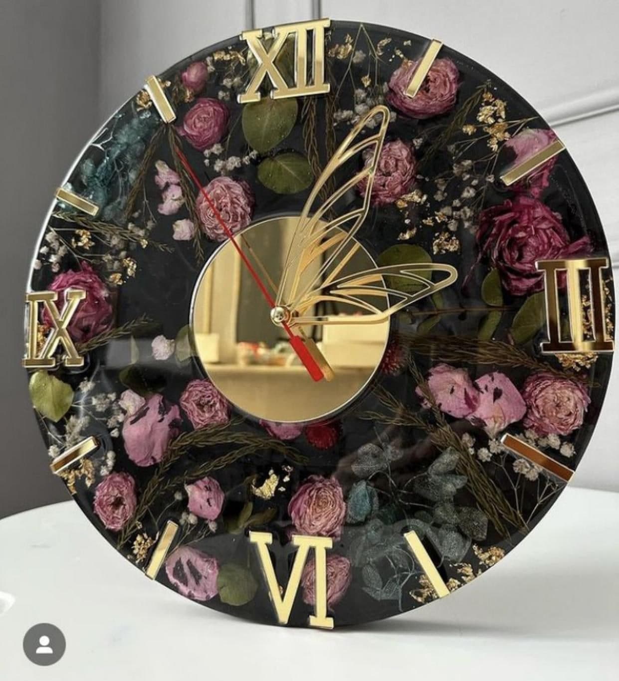 Botanical wall clock with pressed flowers and a gold butterfly